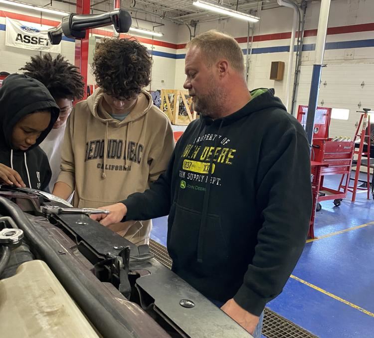  Teacher Guy Olson instructs students on auto repair
